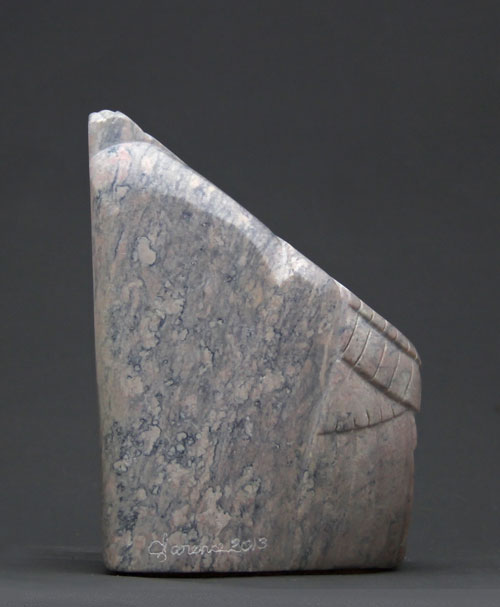 A view of the back of Soapstone Owl #14 by Clarence P. Cameron of Madison, Wisconsin