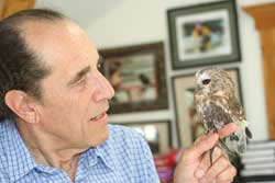 Clarence holding a Saw Whet owl